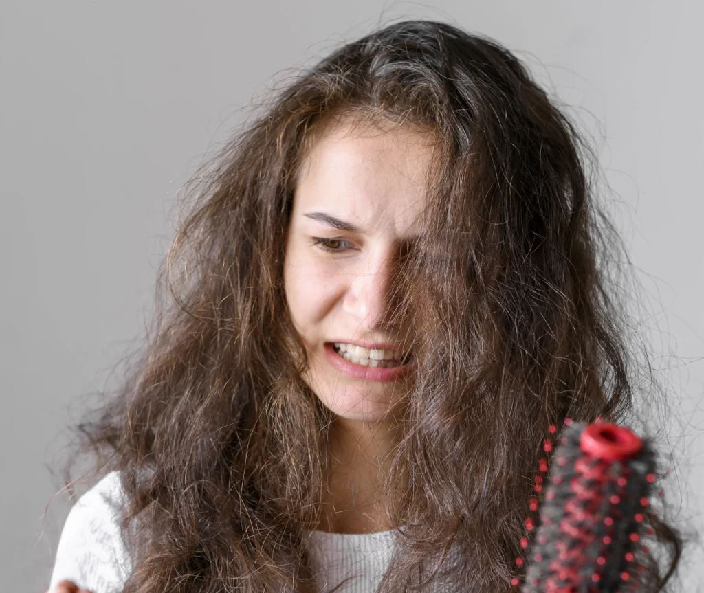 Woman applying HEHR hydrating hair mask to smooth frizzy hair, Doncaster